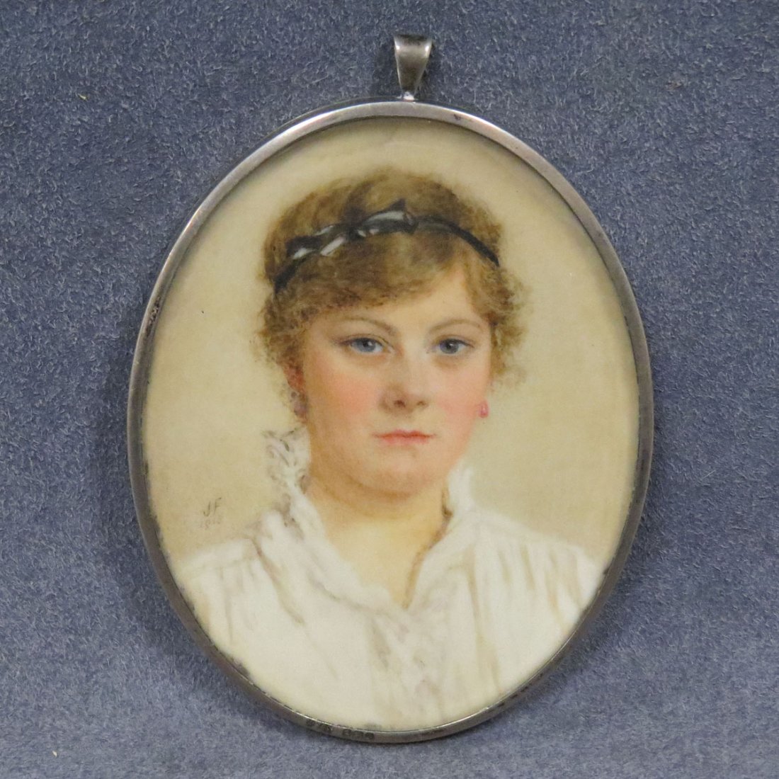 AMERICAN SCHOOL (20TH CENTURY), MINIATURE: AMERICAN SCHOOL (20TH CENTURY), MINIATURE WATERCOLOR ON IVORY, PORTRAIT OF A YOUNG WOMAN, SIGNED J.F., 1915. 3 1/4 X 2 1/2" **CANNOT EXPORT** (DEC #16-55)