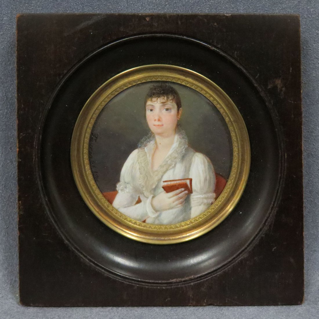 FRENCH SCHOOL (19TH CENTURY), MINIATURE WATERCOLOR: FRENCH SCHOOL (19TH CENTURY), MINIATURE WATERCOLOR ON IVORY, PORTRAIT OF A YOUNG WOMAN WITH BOOK, SIGNED FAVERIN 1806. DIAMETER 2 1/2"; FRAMED AND GLAZED-5 X 5" **CANNOT EXPORT** (DEC #16-61)