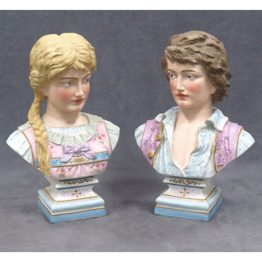 PAIR GERMAN BISQUE PORCELAIN DECORATED: PAIR GERMAN BISQUE PORCELAIN DECORATED BUSTS OF YOUNG MAN AND WOMAN. HEIGHT 13 1/2"