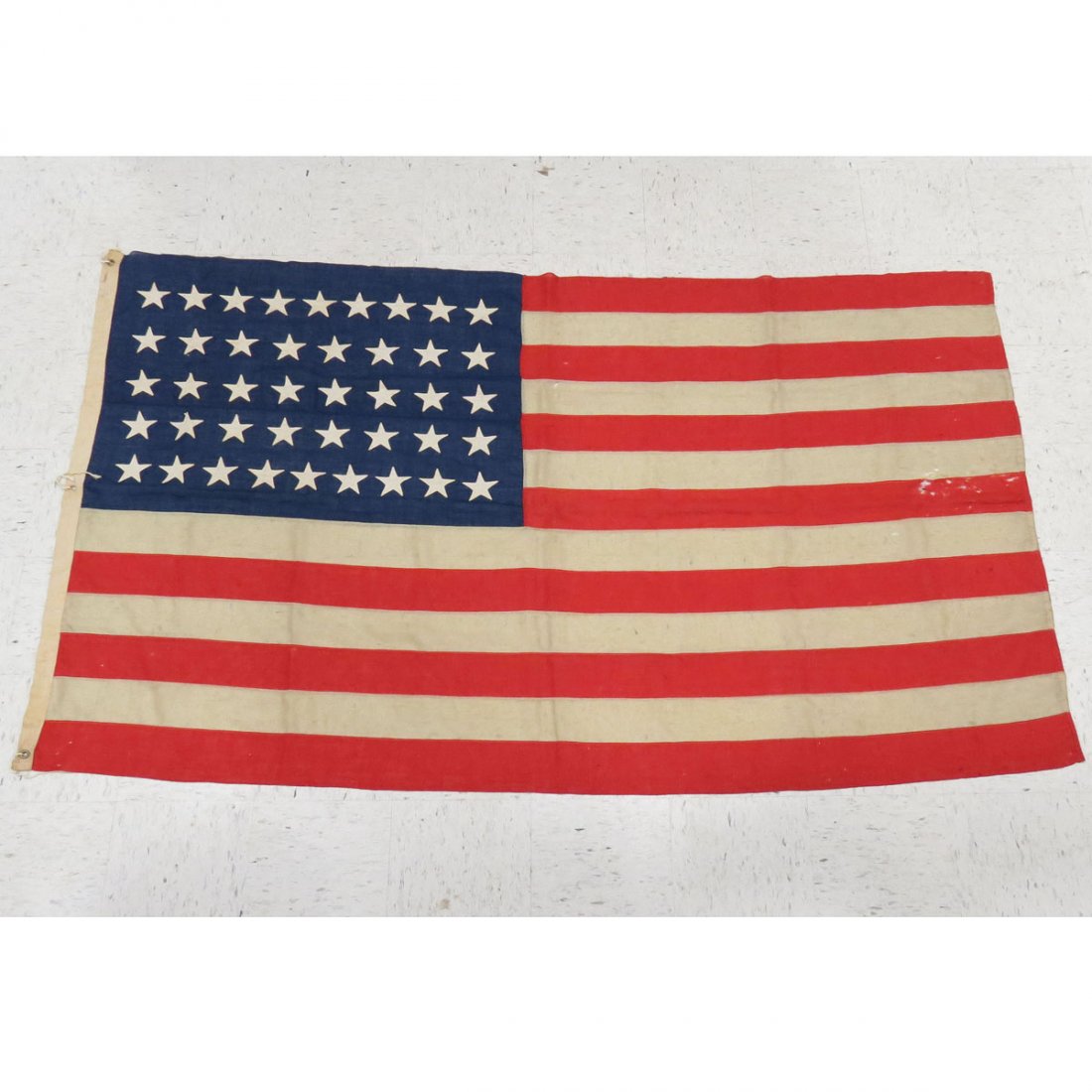 U.S. NAVY 42-STAR FLAG (JULY 3-10TH 1890): U.S. NAVY 42-STAR FLAG (JULY 3-10TH 1890) USED BY U.S. NAVY UNTIL JULY 4 1891, LINEN WITH HAND APPLIED STARS (BOTH SIDES), CANVAS BINDING SIGNED "PEASE". APPROX 60 X 96"