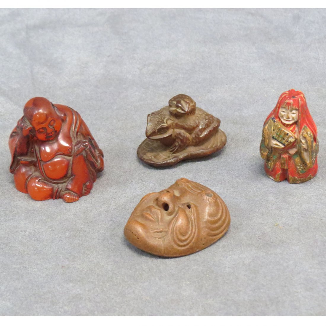 LOT (4) ASSORTED JAPANESE NETSUKE: LOT (4) ASSORTED JAPANESE NETSUKE INCLUDING CARVED AND POLYCHROME WOOD FIGURE, HEIGHT 1 3/4"; BOXWOOD TOADS, SIGNED ISSHIN, LENGTH 1 3/4"; POTTERY MASK, SIGNED SEKIDEN, HEIGHT 2", SEATED FIGURE, SIGNE