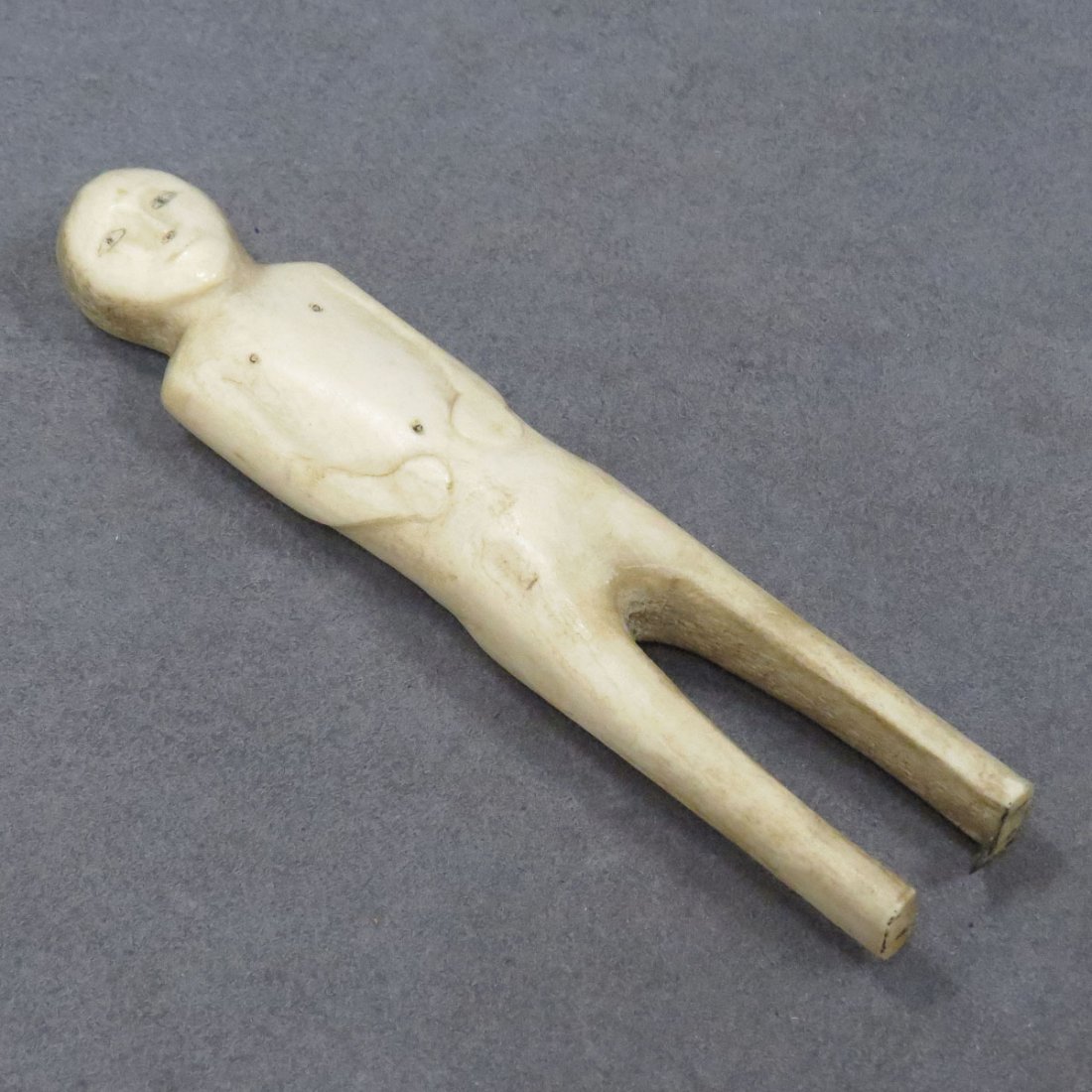 INUIT CARVED BONE FIGURE OF MAN: INUIT CARVED BONE FIGURE OF MAN. HEIGHT 6" **CANNOT EXPORT**
