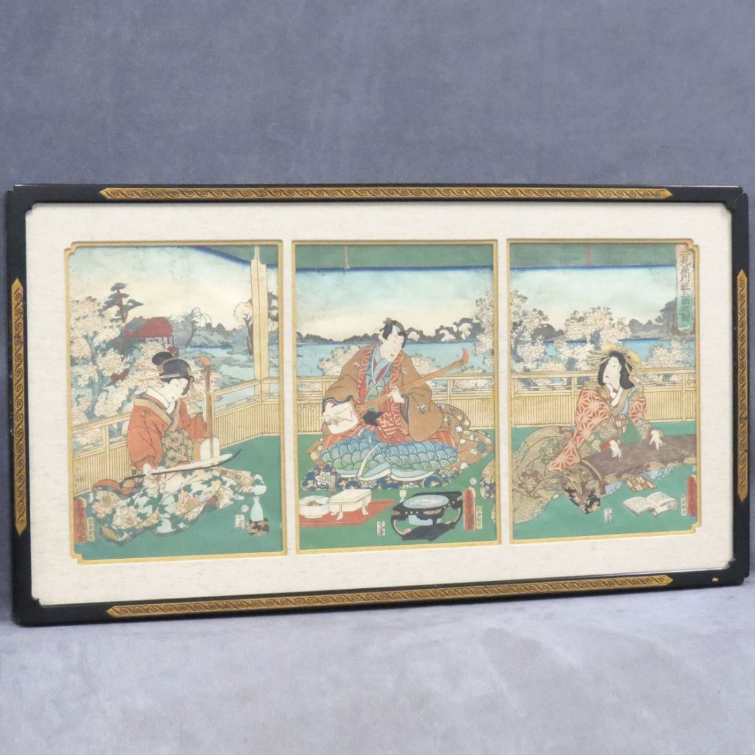 TOYOKUNI III, UKIYO-E COLOR WOODBLOCK TRIPTYCH: TOYOKUNI III, UKIYO-E COLOR WOODBLOCK TRIPTYCH, MUSICIANS. SIGHT 13 3/4 X 29 1/2"; FRAMED AND GLAZED-19 X 35"