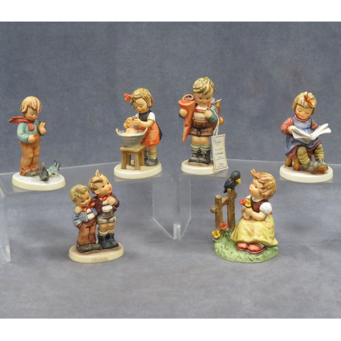 LOT (6) GOEBEL HUMMEL FIGURES: LOT (6) GOEBEL HUMMEL FIGURES, TMK-5, TMK-6, AND SPECIAL EDITIONS INCLUDING MAX AND MORITZ, #123, HEIGHT 5 1/4"; SING WITH ME, #405, HEIGHT 5"; WHAT'S NEW, #418, HEIGHT 5 1/4"; DOLL BATH, #319, HEIGHT