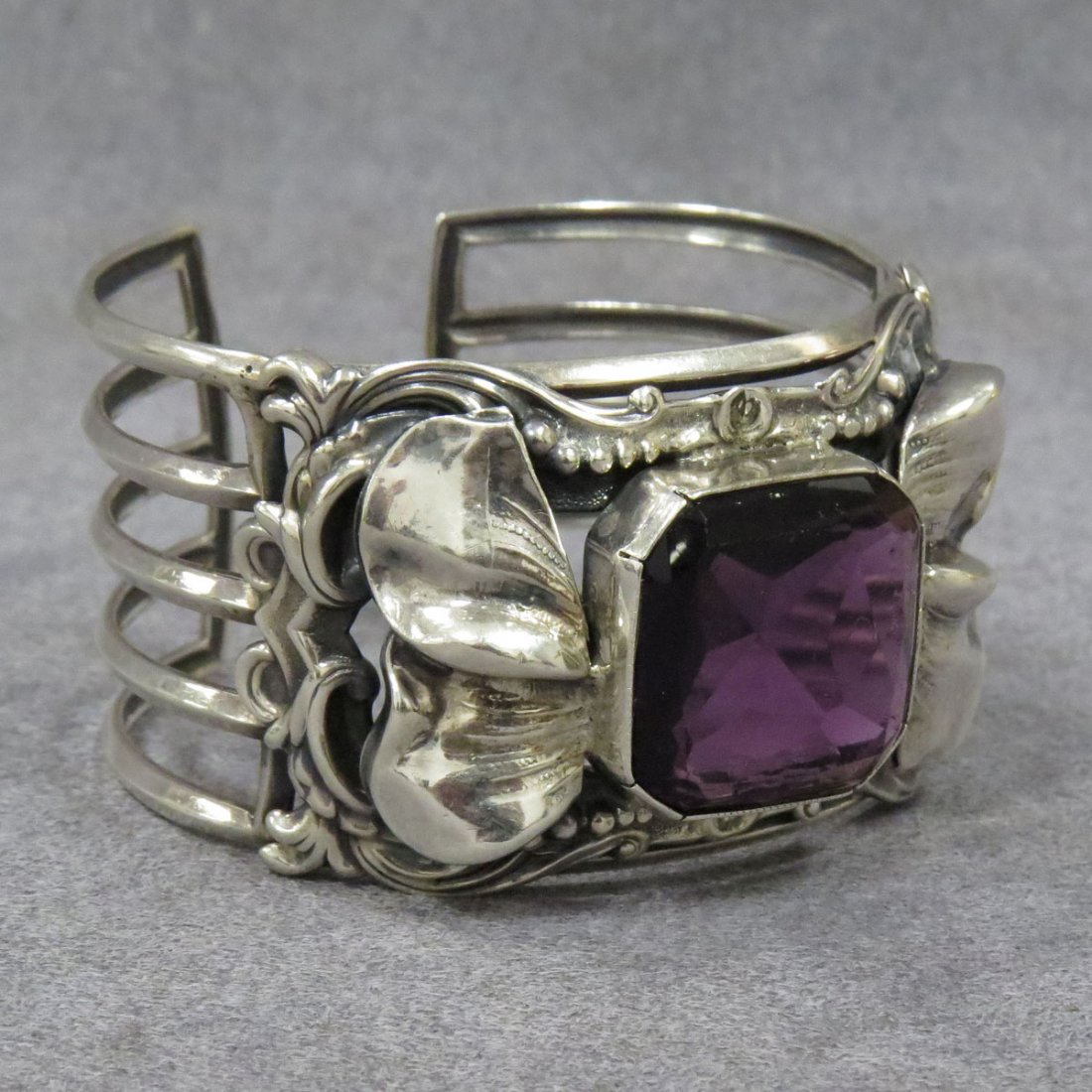 ART NOUVEAU STYLE STERLING 3-BAND CUFF BRACELET: ART NOUVEAU STYLE STERLING 3-BAND CUFF BRACELET SET WITH PURPLE PASTE SET STONE. WIDTH 2 1/8"; GROSS WEIGHT 1.48 OZT