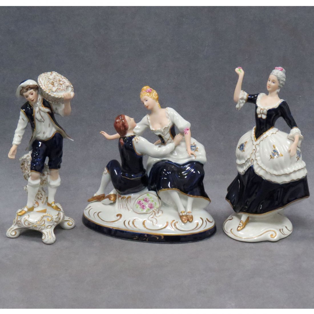 LOT (4) ROYAL DUX COBALT DECORATED FIGURES: LOT (4) ROYAL DUX COBALT DECORATED FIGURES. HEIGHT 8 1/2"-9 1/2" (1/WITH LABEL)