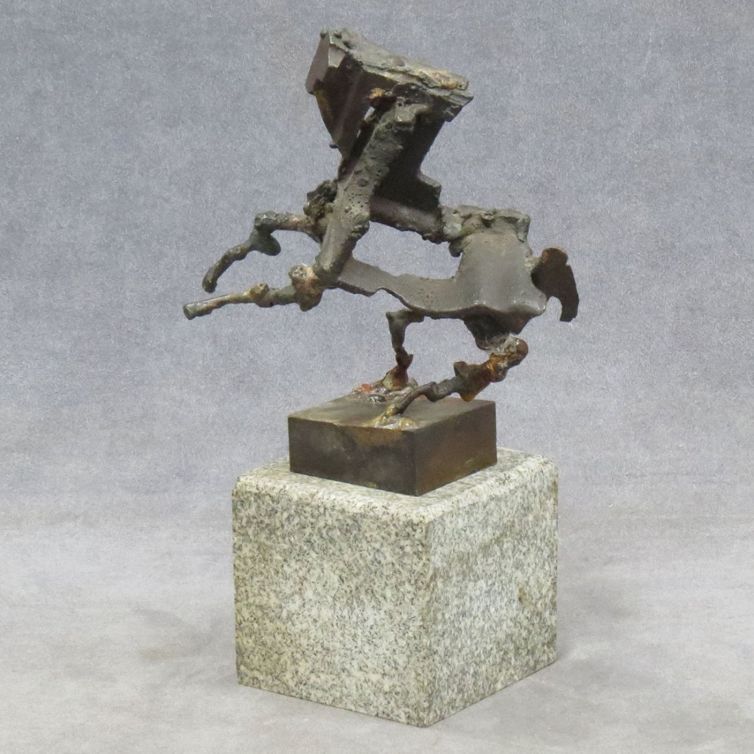 JUDITH BROWN (AMERICAN NY 1932-1992), IRON: JUDITH BROWN (AMERICAN NY 1932-1992), IRON SCULPTURE, "REX" WITH STONE BASE. HEIGHT 10 3/4" (REPAIRED)