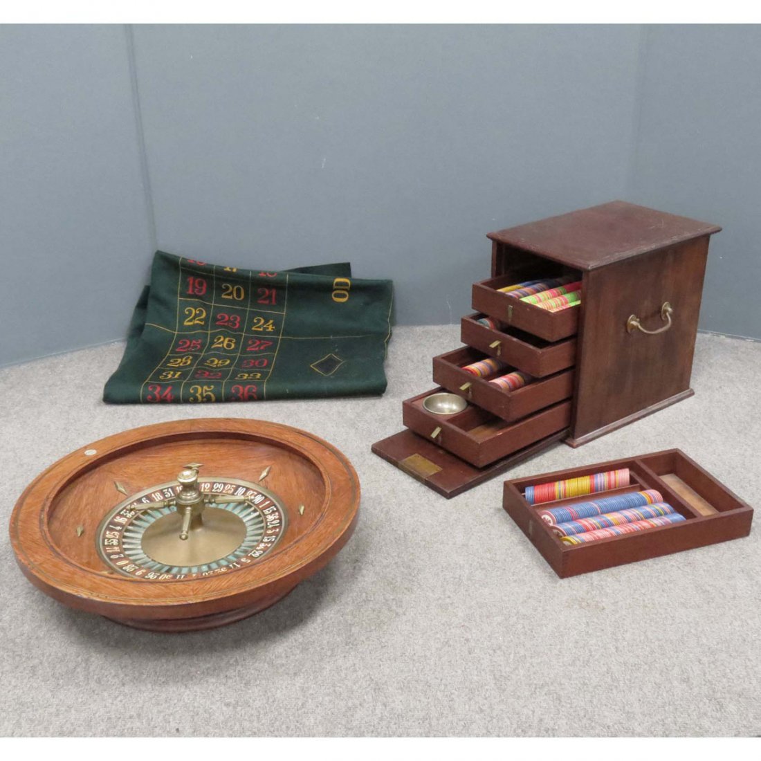LOT (2) JOST ET CRE, PARIS ROULETTE WHEEL: LOT (2) VINTAGE JOST ET CRE, PARIS INCLUDING INLAID OAK AND BRASS ROULETTE WHEEL, SIGNED, DIAMETER 22" AND MAHOGANY GAMING CHIP CABINET, SIGNED, HEIGHT 15 1/2"; WIDTH 10" WITH PAINTED ROULETTE TABLE F