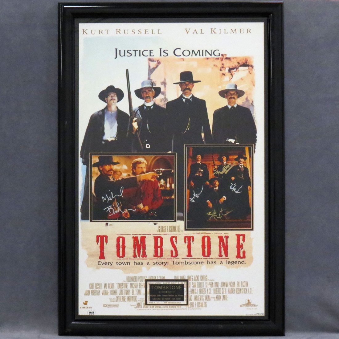 TOMBSTONE MOVIE POSTER WITH INSET PHOTOS: TOMBSTONE MOVIE POSTER WITH INSET PHOTOS, SIGNED BY CAST MEMBERS INCLUDING MICHAEL BLEHN, POWERS BOOTH, VAL KILMER, SAM ELLIOT, BILL PAXTON AND KURT RUSSELL. FRAMED AND GLAZED-39 X 26 1/2"