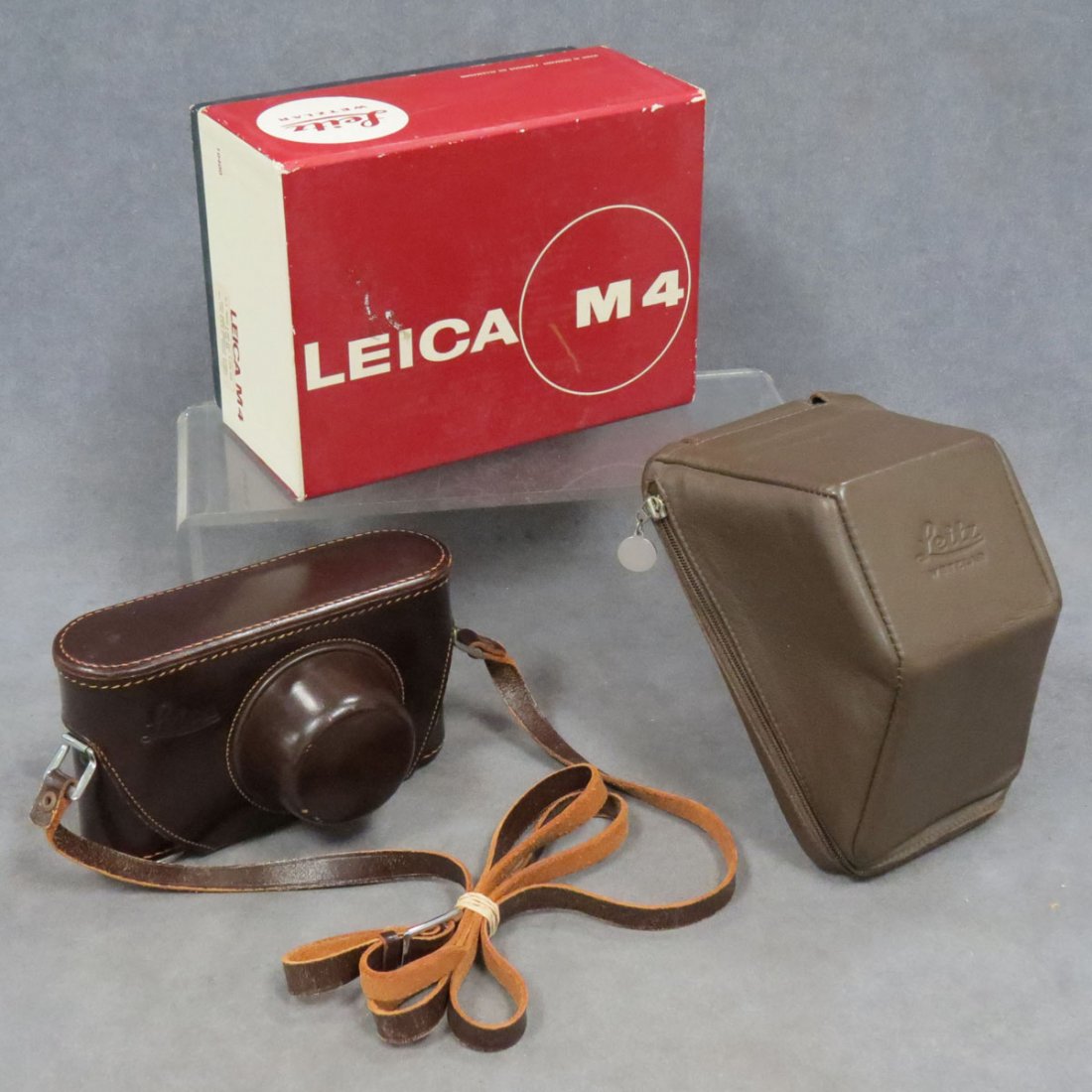 LOT (3) LEICA INCLUDING BROWN HARD LEATHER CASE: LOT (3) LEICA INCLUDING BROWN HARD LEATHER RANGEFINDER CAMERA CASE WITH STRAP (UNUSED); BROWN SOFT LEATHER M4 CAMERA CASE WITH STRAP AND M4 CAMERA BOX
