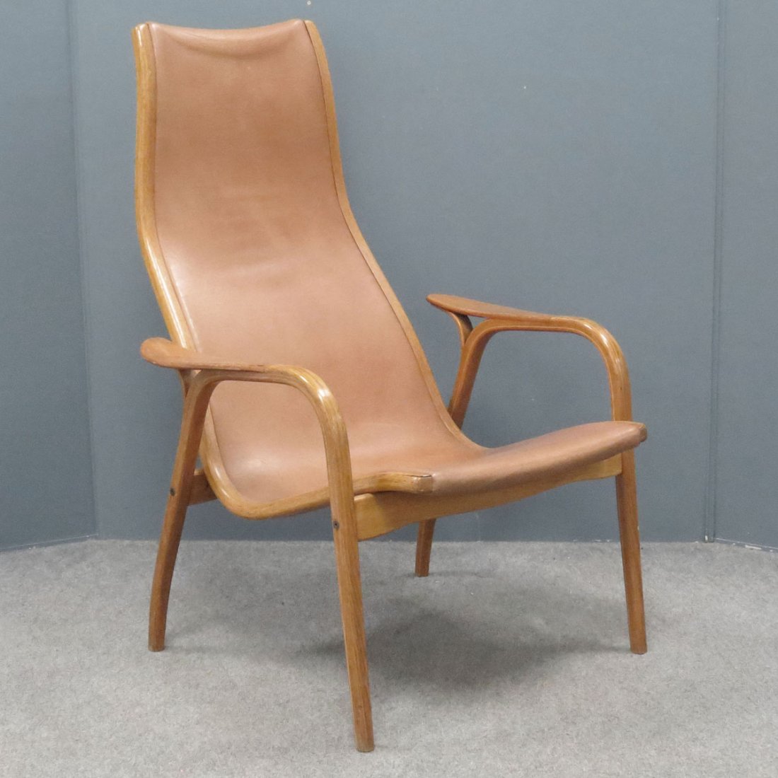YNGVE EKSTROM, "LAMINO" LOUNGE CHAIR: YNGVE EKSTROM SWEDISH BUFFALO HIDE LEATHER "LAMINO" LOUNGE CHAIR. HEIGHT 39"; WIDTH 30"; DEPTH 30"