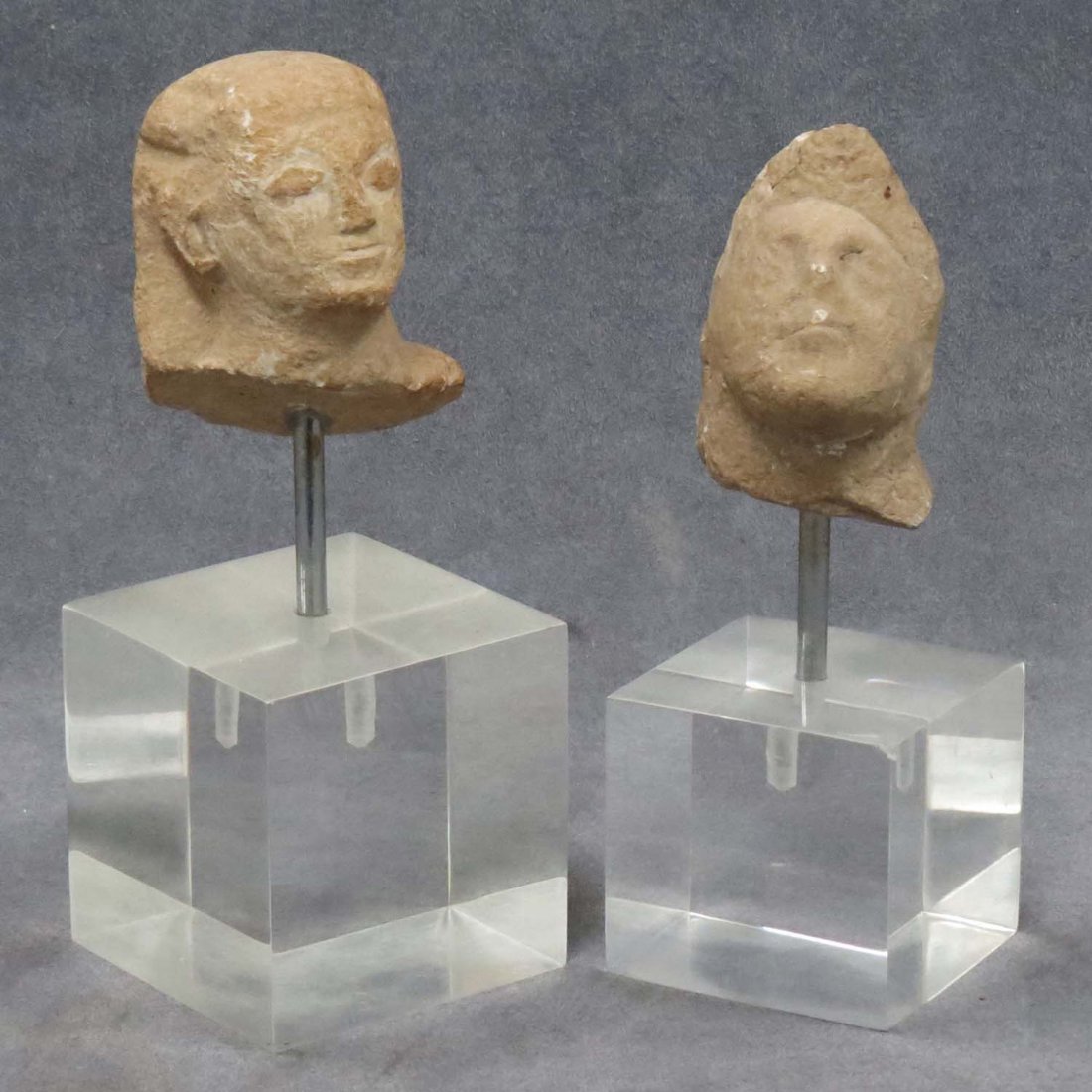 LOT (2) ANCIENT EGYPTIAN/ROMAN CARVED STONE HEADS: LOT (2) ANCIENT EGYPTIAN/ROMAN CARVED STONE FRAGMENT HEADS, MOUNTED. APPROXIMATE HEIGHT 3"