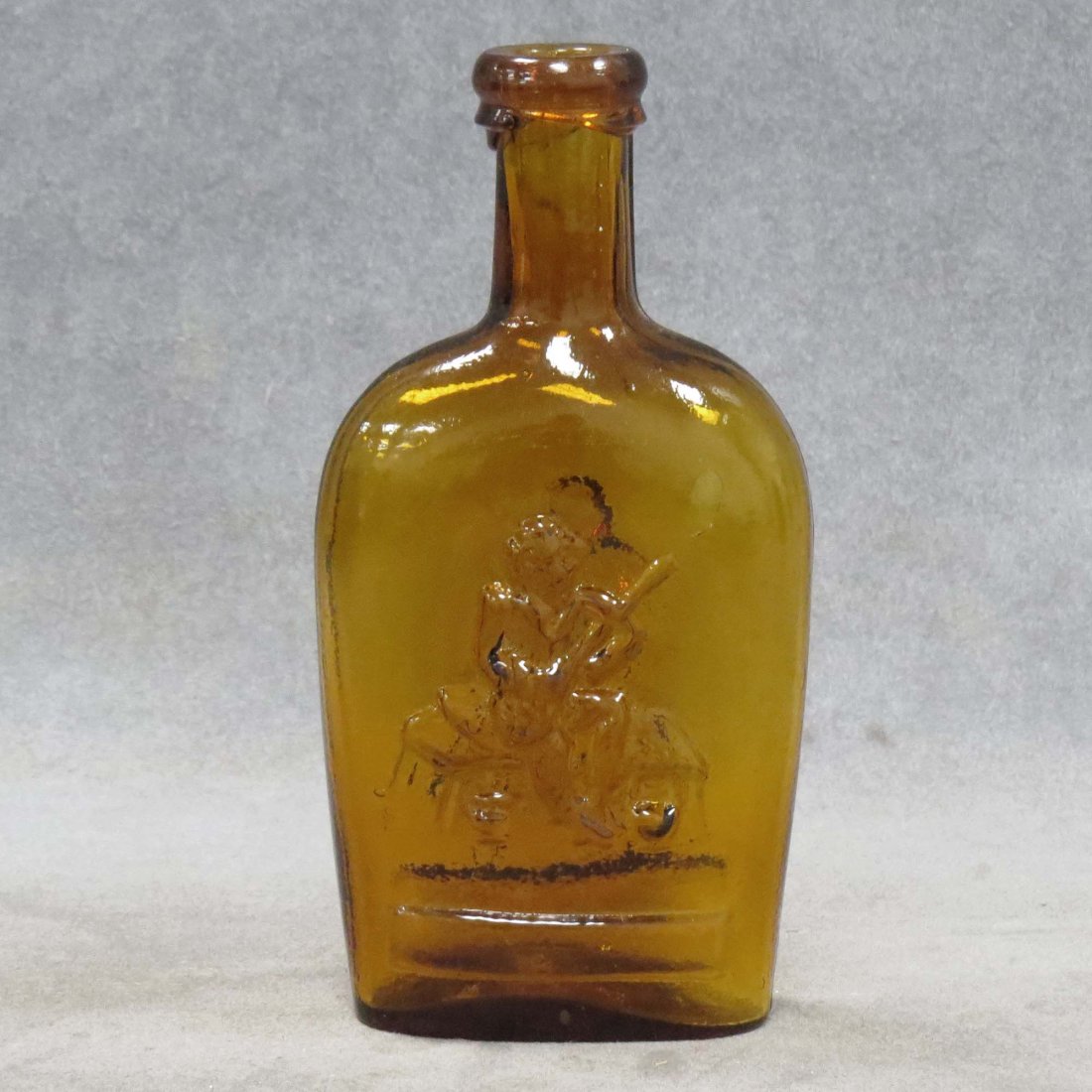 VINTAGE AMBER HALF PINT FLASK, MUSICIAN/DANCER: VINTAGE AMBER HALF PINT FLASK, MUSICIAN/DANCER, 19TH CENTURY. HEIGHT 6 5/8"