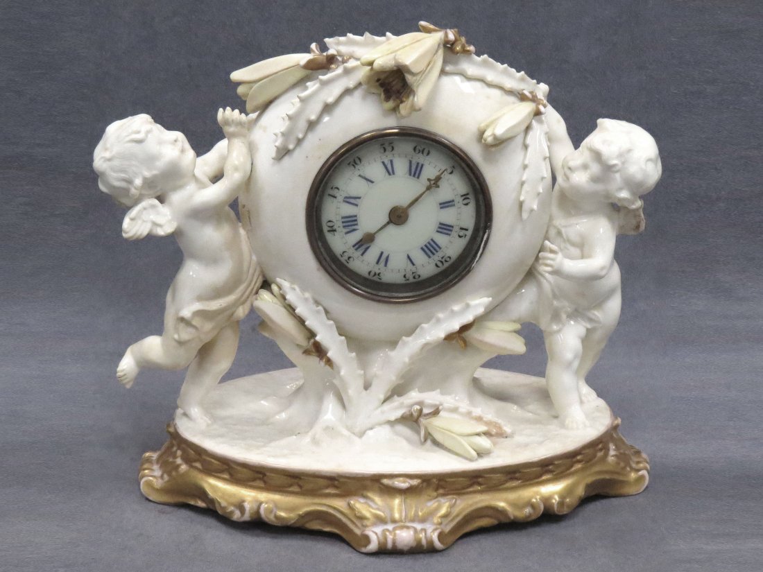SAMUEL MOORE FIGURAL PORCELAIN CASE SHELF CLOCK: SAMUEL MOORE FIGURAL PORCELAIN CASE SHELF CLOCK, 19TH CENTURY. HEIGHT 9" (IMPERFECTION)