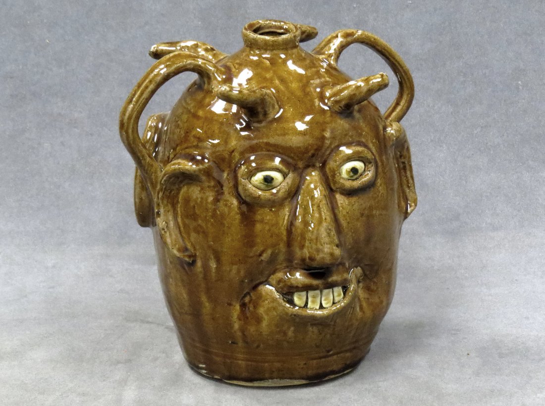 REGGIE MEADERS (GEORGIA 1916-2009) FACE JUG: REGGIE MEADERS (GEORGIA 1916-2009), SOUTHERN FOLK ART POTTERY DOUBLE SIDED FACE JUG, SIGNED. HEIGHT 9"