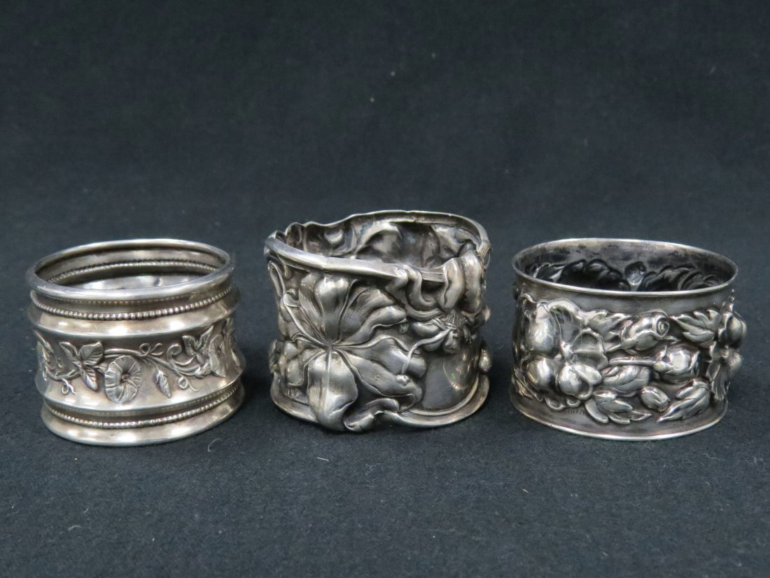 LOT (3) ART NOUVEAU STERLING NAPKIN RINGS: LOT (3) ART NOUVEAU STERLING NAPKIN RINGS. DIAMETER 1 5/8-1 3/4"; TWT 1.92 OZT