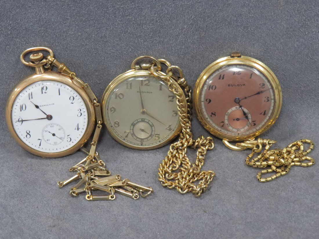 LOT (3) ASSORTED VINTAGE POCKET WATCHES: LOT (3) ASSORTED VINTAGE GOLD FILLED OPEN-FACE POCKET WATCHES INCLUDING HAMILTON 17-JEWEL 910 WITH CHAIN (47MM); HAMILTON 17-JEWEL 917 WITH CHAIN (45MM); BULOVA 17-JEWEL 17AE WITH CHAIN (50MM)