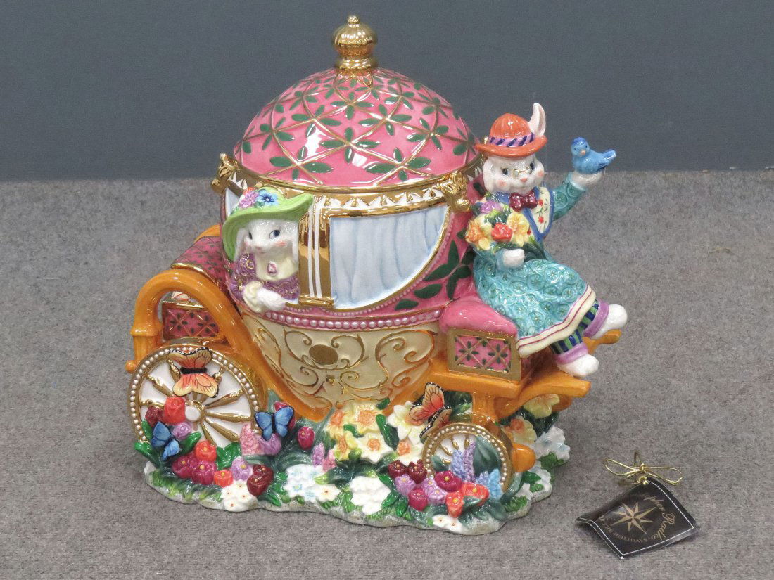 CHRISTOPHER RADKO PORCELAIN COOKIE JAR: CHRISTOPHER RADKO DECORATED PORCELAIN "DAPPER HARE CARRIAGE COOKIE JAR", 2002. HEIGHT 13 1/2"; LENGTH 13 1/2" (ORIGINAL TAG AND BOX)