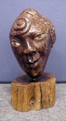AMERICAN SCHOOL (MID-20TH CENTURY), CARVED STONE: AMERICAN SCHOOL (MID-20TH CENTURY), CARVED STONE HEAD OF A WOMAN, SIGNED "PAUL" WITH WOOD BASE. HEIGHT 14"