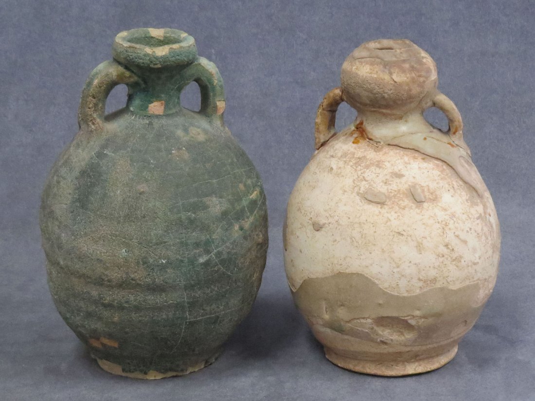 LOT (2) ISLAMIC POTTERY DOUBLE HANDLE JUGS: LOT (2) ISLAMIC POTTERY DOUBLE HANDLE JUGS, C.1000 AD. HEIGHT 7-7 3/8" (RESTORED)