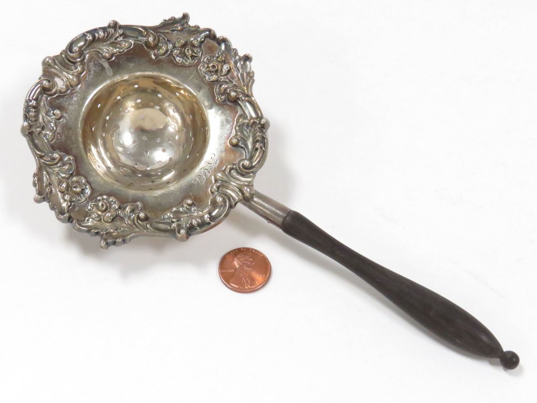 GRAFF, WASHBOURNE AND DUNN STERLING TEA STRAINER: GRAFF, WASHBOURNE AND DUNN STERLING TEA STRAINER, MONOGRAMMED, WITH EBONY HANDLE. LENGTH 8"