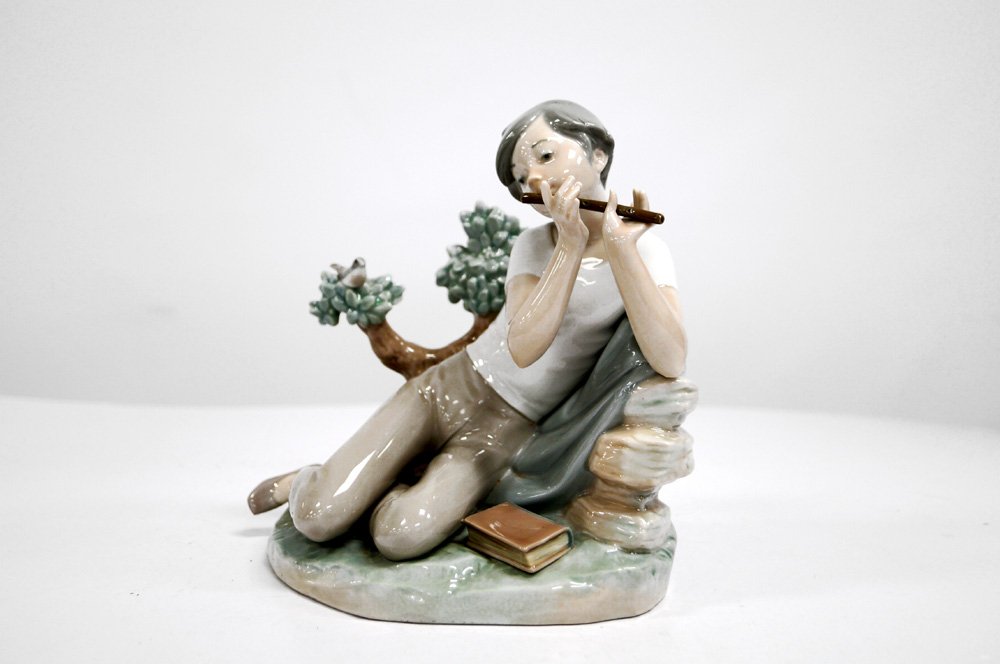 LLADRO DECORATED PORCELAIN FIGURE, "STUDENT FLUTE (1 of 2)