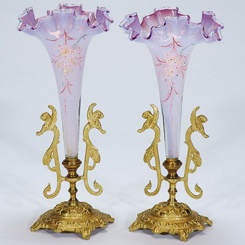 Pr. Victorian epergnes, lilac,metal bases, 10 1/2": Pair of Victorian epergnes surmounted within gilded bases, the side ornaments cast as Griffins. The frilly rims of the vases are in a pretty lilac color, the opalescent bodies were deftly decorated wi