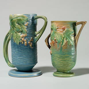 2 Roseville Bushberry : vase, shape 32-7"crack; vase: Two Bushberry with raised marks. Blue vase, 32-7", height 7 1/8 inches. Blistered glaze, crack in handle. Green vase, 29-6", height 6 1/4 inches. Color runs, good mold.