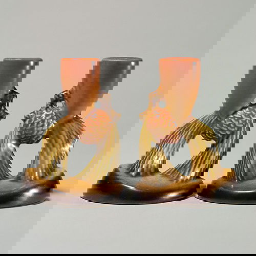 Pair Roseville brown Pine Cone candlesticks, 451-4: Pair of Pine Cone candlesticks in brown, shape 451-4. Impressed marks. Height 4 1/4 inches. One of the candlesticks has a repair at the rim.