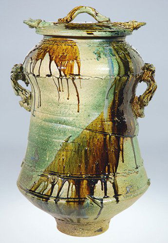 Don Reitz covered urn, 33 1/2": Monumental covered urn done by noted potter Don Reitz. The two handled urn is first thrown then pushed, pulled, incised and carved before the addition of several gloss glazes. Signed "Reitz" on the si