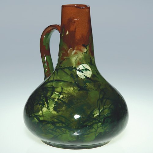 Rookwood 6" claret pitcher, moon & birds, AH, 188: Claret Pitcher, formed of red clay, decorated with a night time scene of birds flying beneath a full moon with Oriental grasses also present, finished in a Limoges glaze, the work of Albert Humphreys