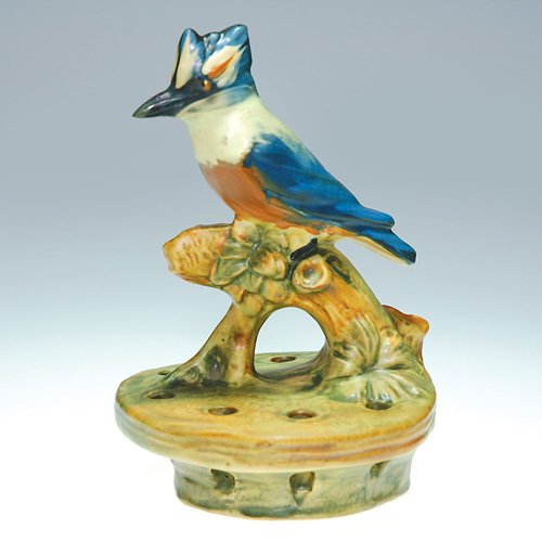 Weller Muskota 'Kingfisher" 6 1/2" flower frog: Weller 6 1/2 inch flower holder showing a colorful kingfisher seated on a branch. Impressed Weller in block letters. Light crazing with repair to the beak.
