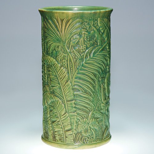 Weller Marvo 19 3/8" umbrella stand in green: Weller Marvo 19 3/8 inch umbrella stand with molded design of lush, tropical jungle growth and covered with a mat green glaze. The only marks are incised numbers on the bottom. There is fine overall c
