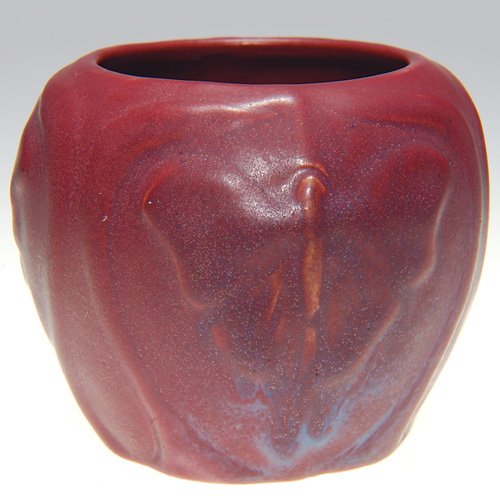 Van Briggle 2 7/8" vase, butterflies, 1917, Mulber: Van Briggle 2 7/8 inch vase with three panels, each featuring a butterfly with its wings spread, cast in 1917 and covered with Mulberry glaze. Marked with the Van Briggle logo and the date. There is f