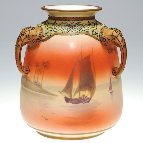 Nippon Moriage 'elephant" handle vase, scene, 6: Nippon Moriage vase with three 'elephant head" handles, the shoulder ornate with enameled tapestry design, the body hand painted with sailing vessels nearing an island with palm trees. Height 6 inches