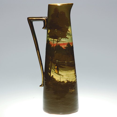 Unknown pottery ewer with high glaze scene: Slender tankard by an unknown maker (probably European) featuring a lone figure strolling a country path towered by brown foliaged trees, a reddish sky in the distance. Signed by the artist J. Hale, t