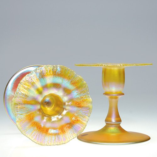 Pr Tiffany flanged candlestands, gold, 3 3/4: Pair of Tiffany candleholders with flanged rims, ribbed and scalloped. Height and diameter is 3 3/4 inches. Each are engraved 'L.C.T. Favrile 1927" and each have the firmÕs embossed paper labels. The