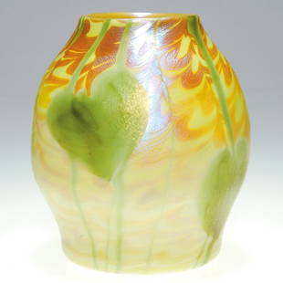 Tiffany attributed vase, leaf & hook design, 4 1/4: Nice Tiffany attributed vase. The 4 inch organic form in yellow custard glass is surrounded with iridescent gold hooked patterns overlaid with dangling green vines and foliage. Height 4 1/4 inches. Un