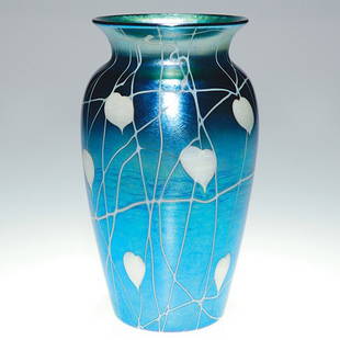 Durand blue vase white design, 7 1/2", signed: Victor Durand vase with white leaves, a few tinged with caramel on the tips dangling from a tangle of vines. The design is bright against the iridescent blue glass. Height 7 1/2 inches. Silver signed