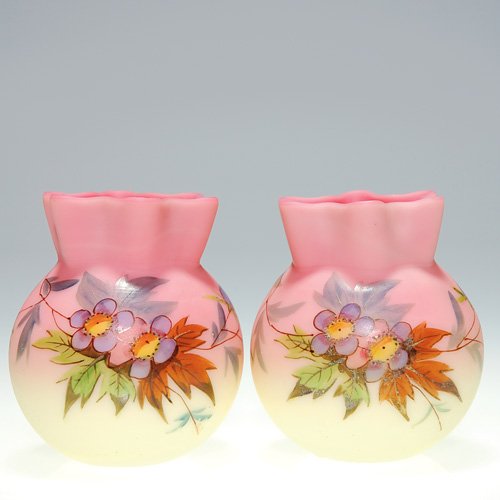 Pr Webb Burmese vases, decorated, 3: Twin Burmese vases created by Thomas Webb & Sons featuring a bouquet of lavender blue blossoms on leafy branches and having a nice six point collar. Heights are 3 inches. A small flat 1/8 inch nick re