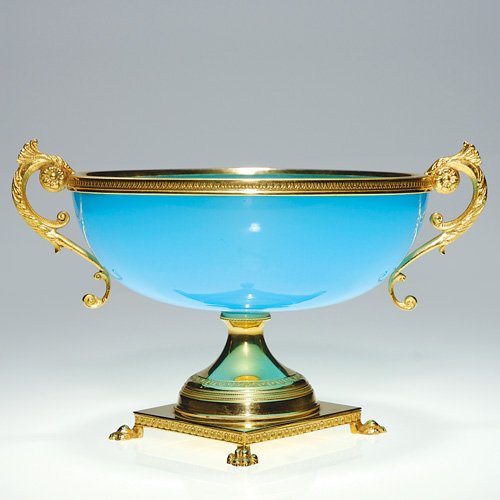 French opaline compote on standard,blue,5 1/4: French opaline compote in blue with gilded rim and fancy scroll handles, elevated on a golden base with paw feet. Height 5 1/4 inches, diameter 7 inches. A paper sticker below the base reads 'Fleurs d