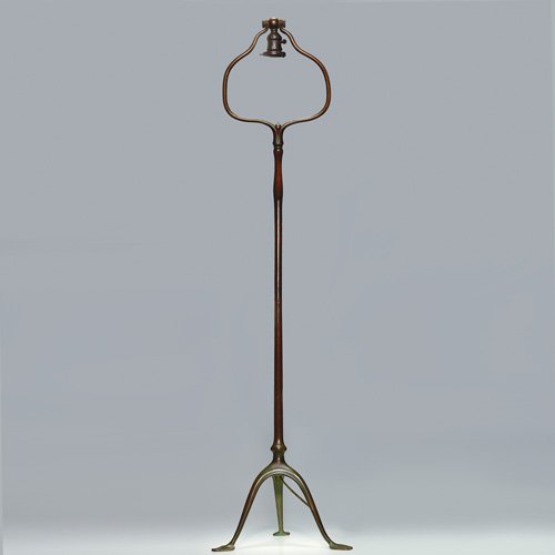 Tiffany floor lamp, 57", no shade: Tiffany bronze floor lamp with tripedal 'spade" feet. Height 55 inches. Impressed 'Tiffany Studios, 428" beneath. The upper section of the socket has been reconstructed. Good patina on the lamp. No sh