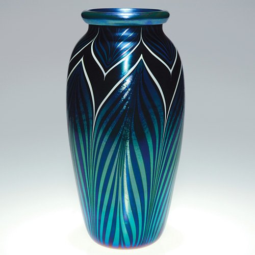 Orient & Flume pulled feather vase, 10 5/8: Dark Orient & Flume vase having a necklace of pulled iridescent blue feathers about the shoulder and feathers pulled up from the base. The plumes are heightened with an application of white that conto