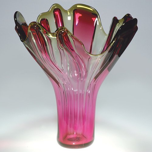 Richard Royal flower form vase, 22 3/4: Imposing floral sculpture vase designed by Richard Royal in the year 1992. This super sized vessel stands 22 3/4 inches, the petal rim expanding 18 1/2 inches. The ribbed body a plum ruby color altern