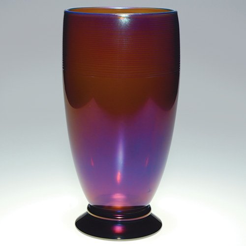Orient&Flume amethyst vase,blu threads,10 1/4",'89: Orient & Flume vase crafted in 1989 by artist David Smallhouse. A simplistic form vase of amethyst glass positioned upon a ringed base, the rim adorned with uniform blue threading. Height 10 1/4 inche