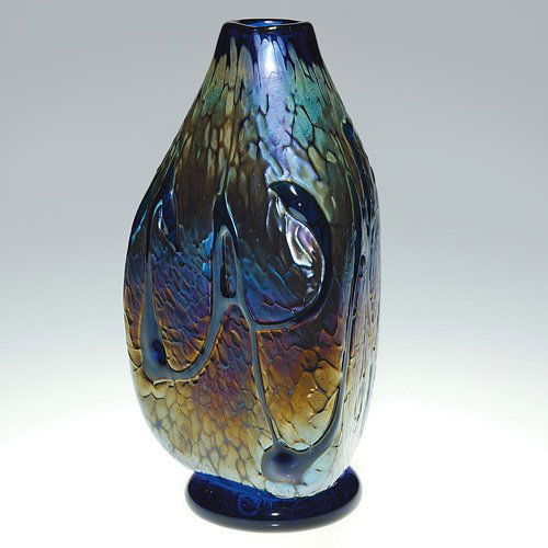 Brent Cox vase, mat texture, glossy design,'91: Brent Cox cobalt triangular vase having a mat textured surface upon which glossy trails were placed. The footed base is signed by the artist beside the 1991 date. Height 8 1/4 inches. Very good condit