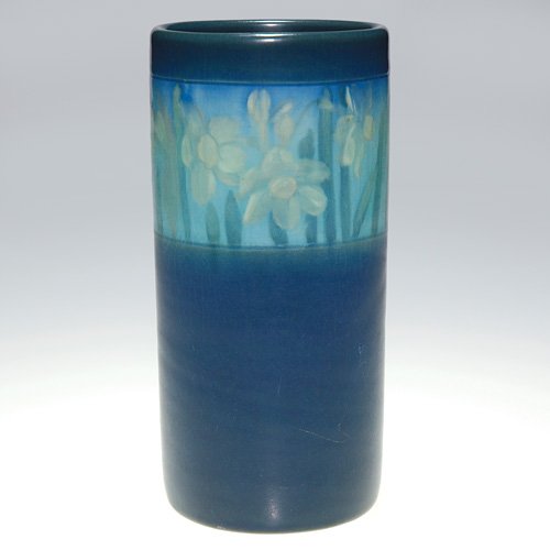 Rookwood Vellum, daffodils, Steinle, 6 3/4": Vellum Glaze 6 3/4 inch vase decorated in 1913 by Caroline Steinle, who encircled the vase with a band of white daffodils, bordered by a rich dark blue glaze. Impressed with the Rookwood logo, the dat