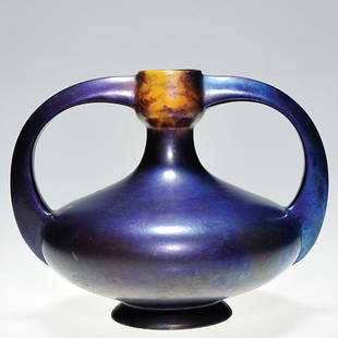 Zsolnay twin handled vase, Eosin blue, 6 3/4": Zsolnay twin handled vase done in iridescent reddish-blue glaze with patches of gold. Marked with a large white Zsolnay Pecs ink stamp logo and also with an oval "Made in Hungary" ink stamp mark. Heig