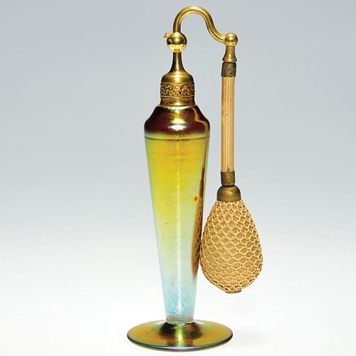 Steuben Gold Aurene atomizer, 7 1/4": Steuben gold Aurene atomizer mounted with an embossed cap that retains the original netted bulb. Height 7 1/4 inches. Shape 6136 in Gardner's "The Glass of Fredrick Carder", page 239. A tiny open bubb