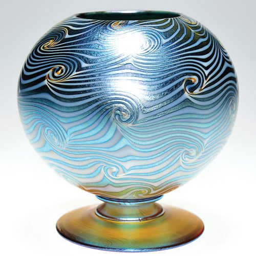 Durand "King Tut" footed vase, 5 1/4": Good Durand vase balanced above a golden foot, the iridescent blue globe displaying the "King Tut" design in opal. Height 5 1/4 inches. The design is evenly combed across the surface and the coiled ar